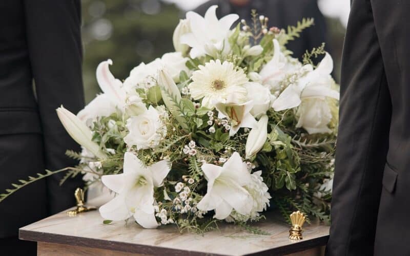 Carrying,Coffin,,Flowers,And,People,At,Funeral,For,Service,,Mourning