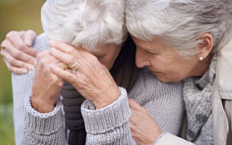 Senior,Women,,Friends,And,Crying,In,Nature,,Embrace,And,Grief