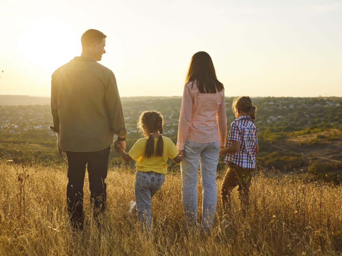 Happy,Family,Enjoying,Sunset,In,Nature,Together.,Back,View,Of